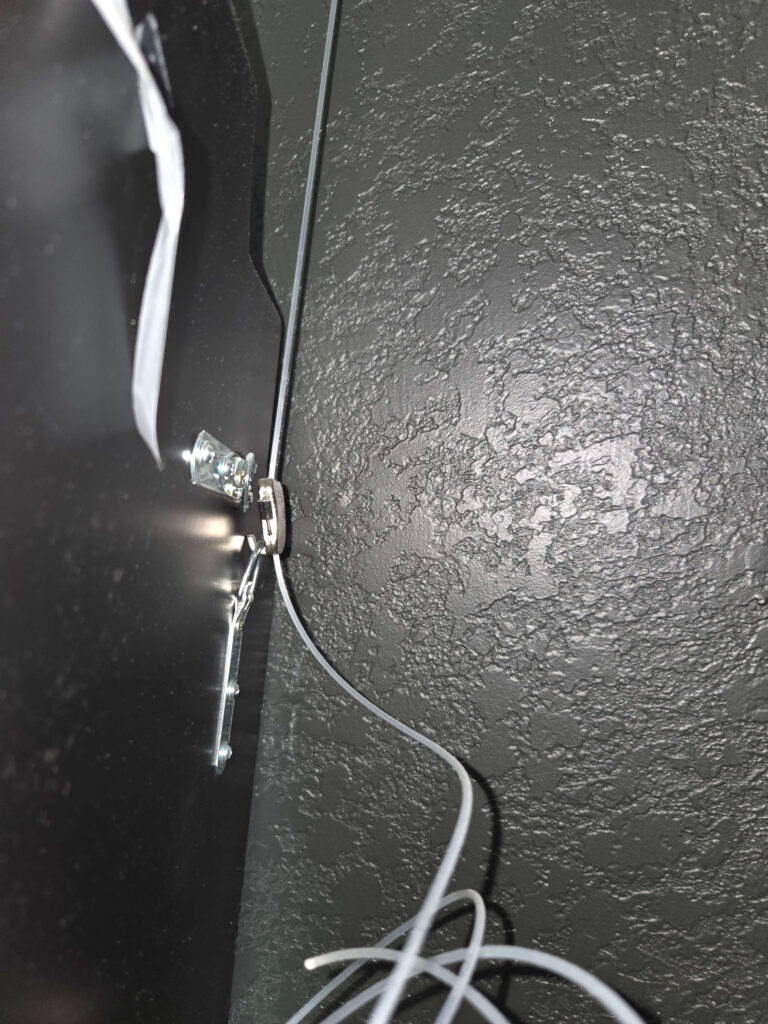 Ways to Hang a Corner Mirror d-ring on back of mirror is hooked to the zipper hook on picture rail system